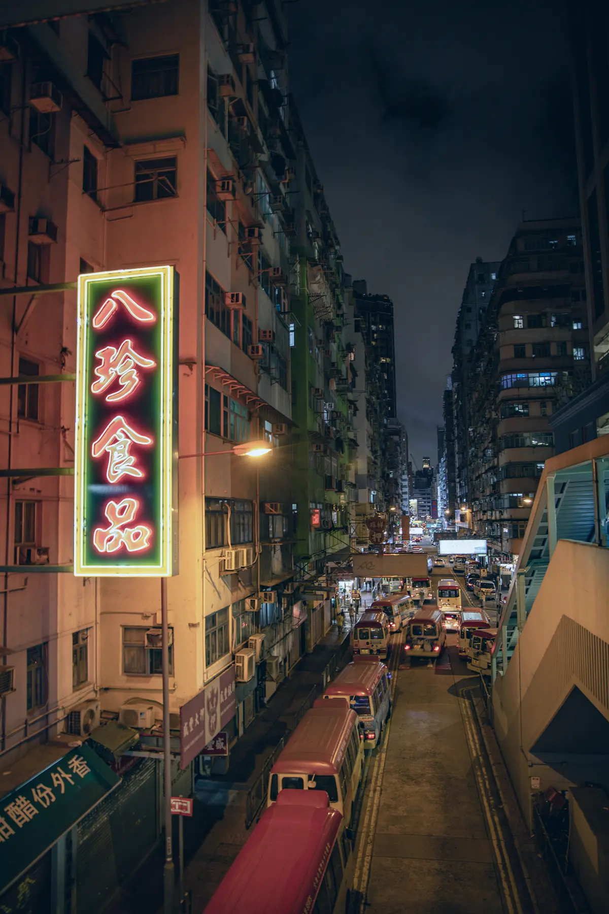 Neon signs above a street in Hong Kong at night